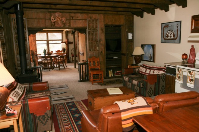 Photo of family sitting area in cozy cabin in Taos Canyon