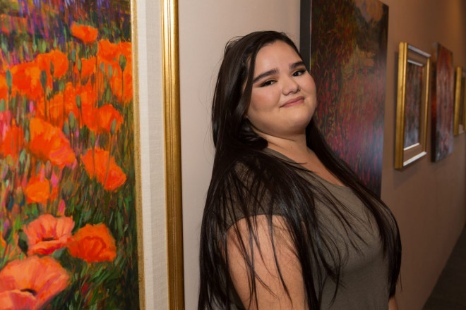 Artist and senior at Taos high school, has pictures taken at Taos Country Club