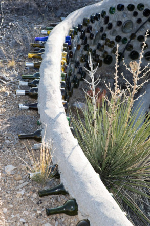 Using glass bottles with concrete to build earth friendly wall in Taos, NM