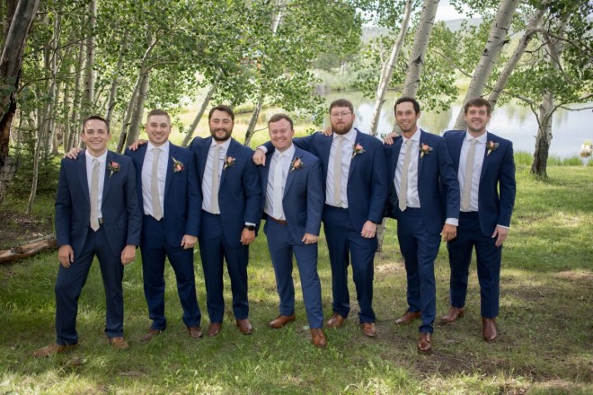Looking sharp in blue suits, Clynt's six groomsmen are ready for the wedding