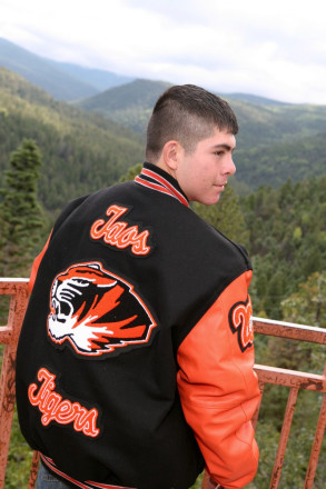 Anthony poses at US Hill overlook for his senior pictures in Taos