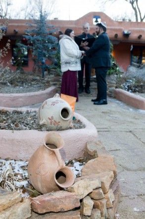 Mexican pottery, Christmas decorations, and adobe adorn this Taos bed and breakfast courtyard