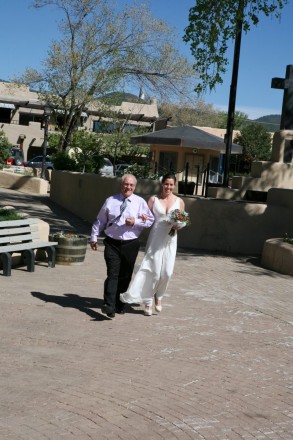 A springtime gust of wind greets this bride and her father in the Taos plaza