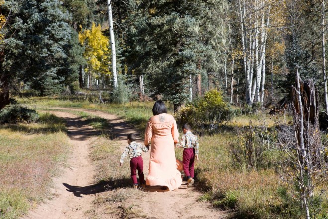 Mom walks with boys for autumn family photos