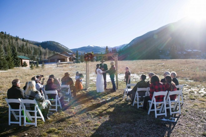 The sun's rays shine on the outdoor October wedding