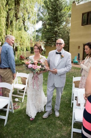 Proud father walks gorgeous bride down wedding aisle