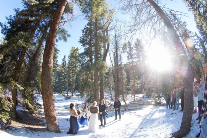 A small group of friends and family watch on as Amberly and Kyle are married in Red River