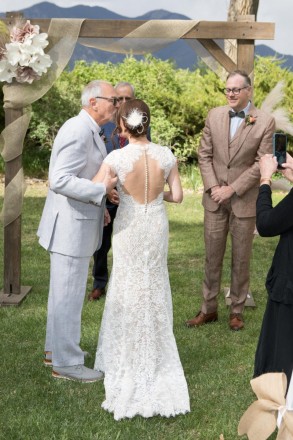Father gives away this Taos bride at outdoor May wedding
