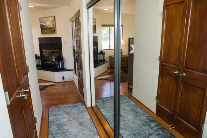 Hallway with large closets and bathroom area in beautiful Taos home