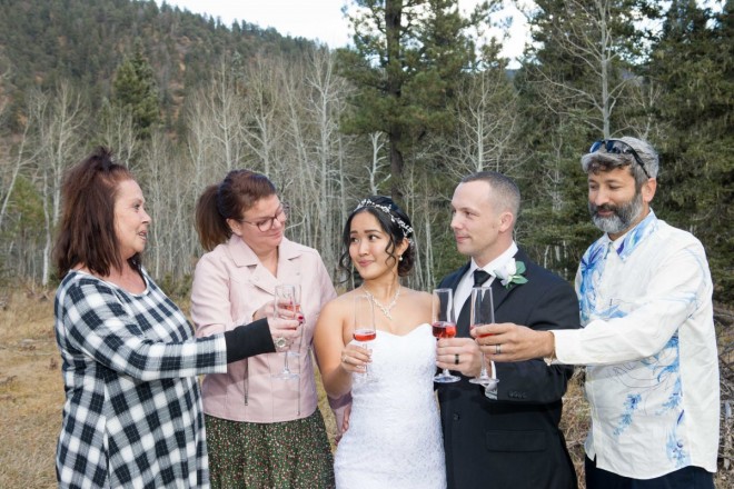 The bride and groom's friends raise a glass on wedding day