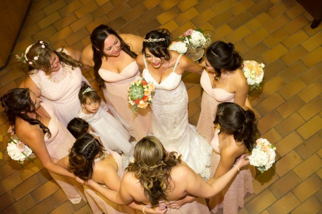 Monica and her bridesmaids enjoy a group hug before the wedding ceremony.