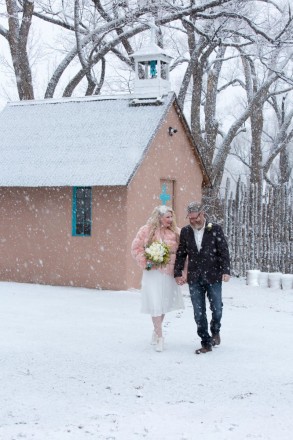 The snow falls on the newlyweds as the Methodist Church in El Prado