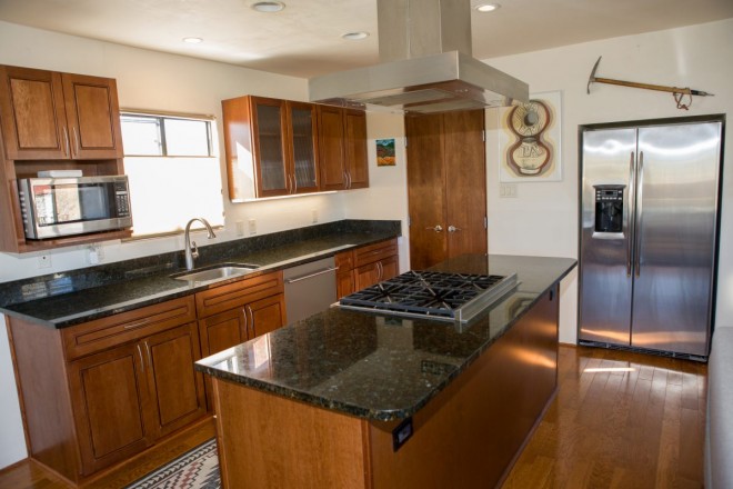 Spacious kitchen and stainless steel refrigerator in rental in Taos, NM