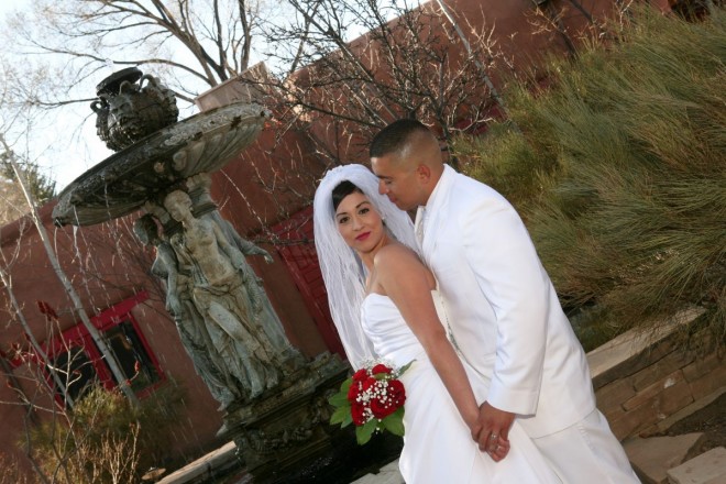 Bride and groom both in white at El Monte Sagrado resort in Taos, NM