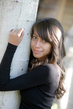 Aspens and sunshine adorn the background of this high school senior