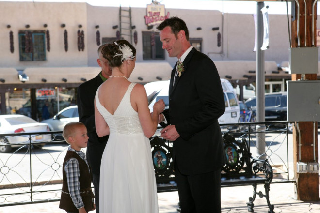 Bride and groom exchange wedding rings under the Taos gazebo