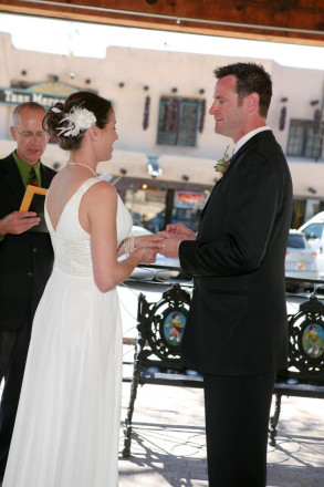 Wedding ceremony with gorgeous adobe Taos architecture in background