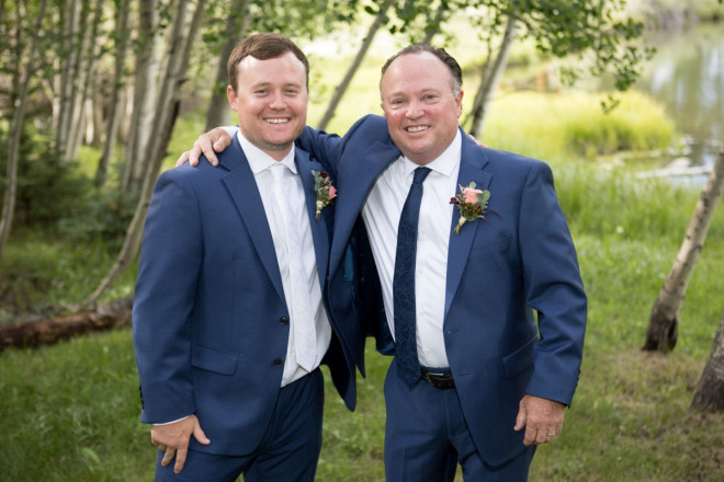 The groom and his father with casual unbuttoned jackets before the wedding