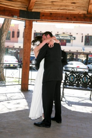 Bride and groom seal their vows with a kiss under the gazebo in Taos, NM