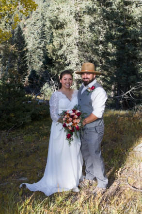 The light and shadows danced on Sarah and Edwardo's faces as they smiled at the altar