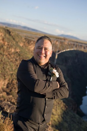 Fernando smiles after his sunrise wedding ceremony at Taos gorge