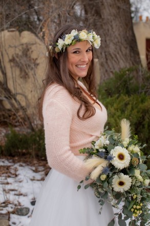 December bride with crown of flowers and winter bouquet