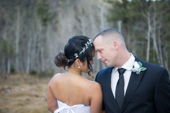 Chisato and Matthew pose with white aspen background at winter wedding