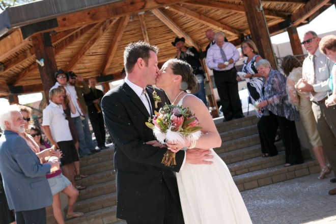 Newlyweds kiss after their Cinco de Mayo springtime wedding in Taos