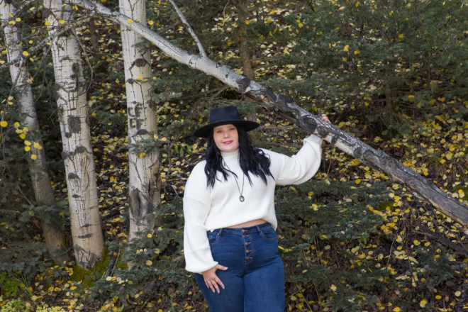 Katy holds onto an aspen tree during her senior photo session in Red River