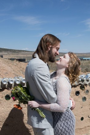 Picture of bride and groom and Trader Joe's bouquet at Earthship in Taos, NM