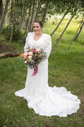 Gorgeous bride in green meadow with aspen trees in Taos Canyon