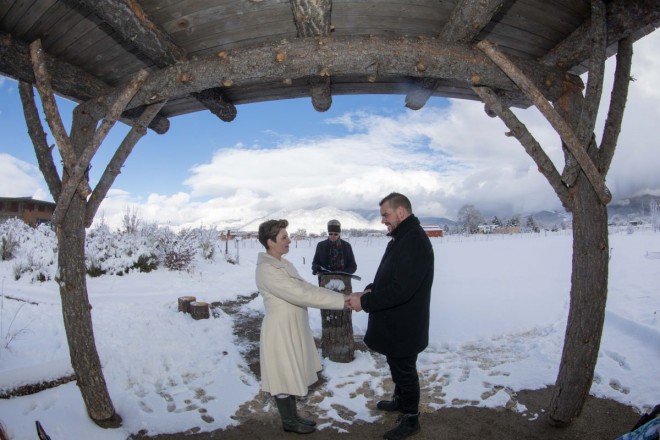 Dan Jones officiates a wedding as the clouds over Taos mountain clear