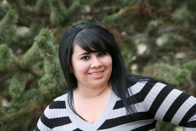 Senior photos in November in Taos with conifer tree background