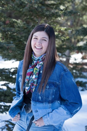 Texas-girl laughs as she has her senior portraits taken outdoors in the snow