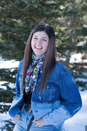 Texas-girl laughs as she has her senior portraits taken outdoors in the snow