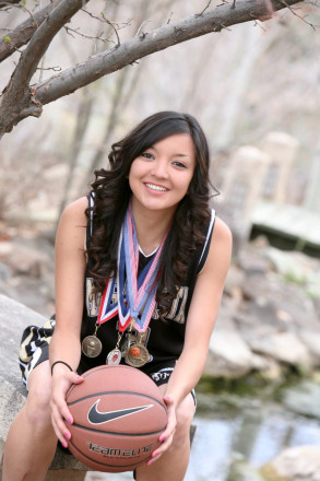 Mesa Vista high school senior poses with basketball and metals