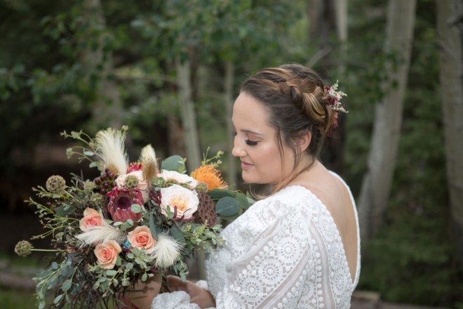 Scarlett admires her bouquet at her wedding in Valle Escondido, NM