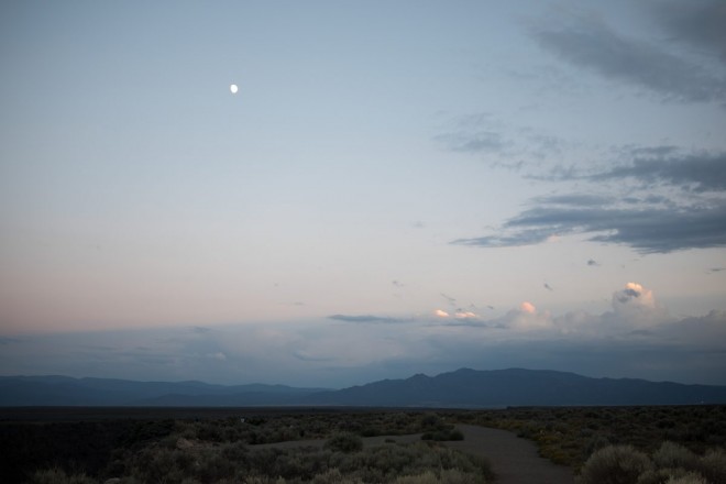 A beautiful evening on the mesa north of Town of Taos with Taos mountains and moon