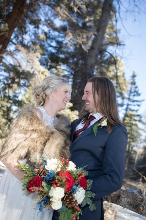 Amberly and Kyle share a laugh after their wintertime mountain wedding