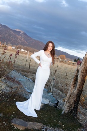 Bride in long sleeve dress by Taos Mountain