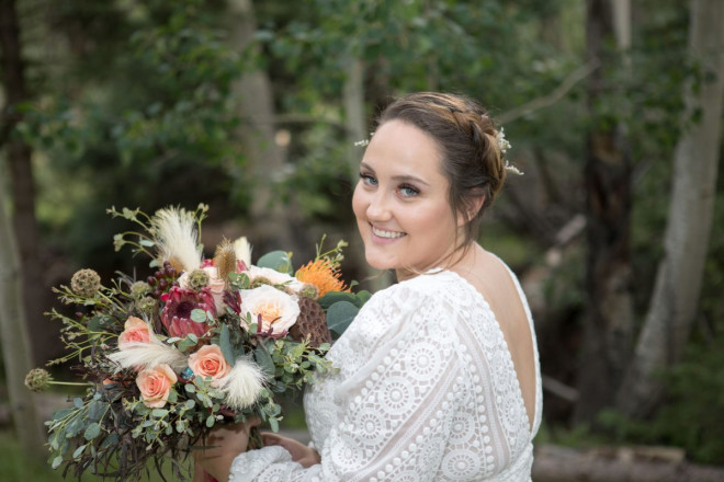 Scarlett, with a long sleeve wedding dress, shows off her killer wedding bouquet