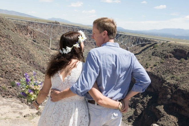 Keri and Robert look at each other at their wedding site at Taos Rio Grande Gorge.