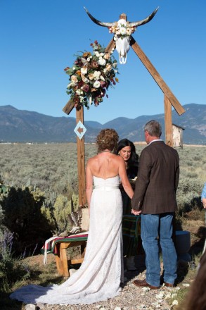 Long horned cow skull with flowers and gorgeous blue Taos skies