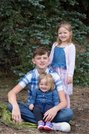 Siblings in blended family pose for a portrait in Angel Fire, NM