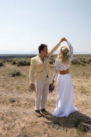Eric spins his bride as they dance in the dessert on wedding day