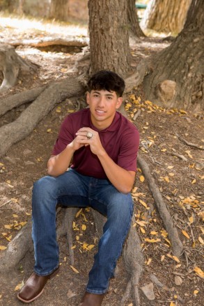 Jacob chills in Mallette Park showing off his Championship ring during senior pictures