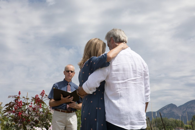 Minister, Dan Jones, reads customized ceremony to Susan and JR at their wedding eloopement.