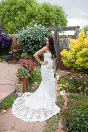 Taos bride wears wedding dress with train at private garden elopement