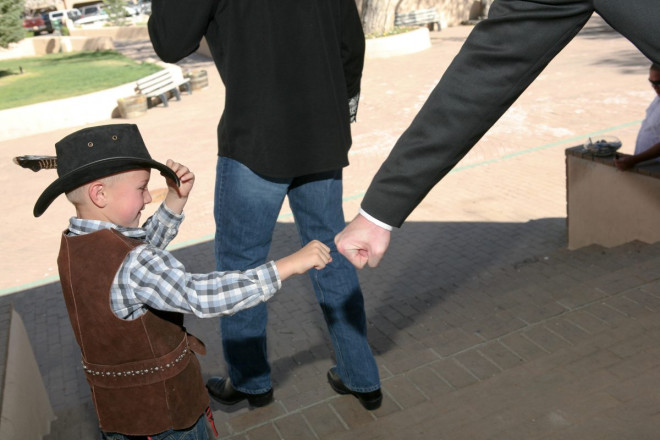 The groom and his ring bearer hit knuckles signifying a job well done