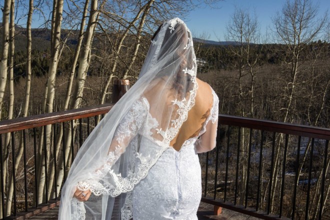 Alysa holds her veil as the wind blows during her bridal portraits